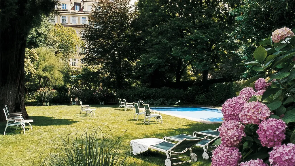 Outdoor pool in the secular park of Parkhotel Laurin