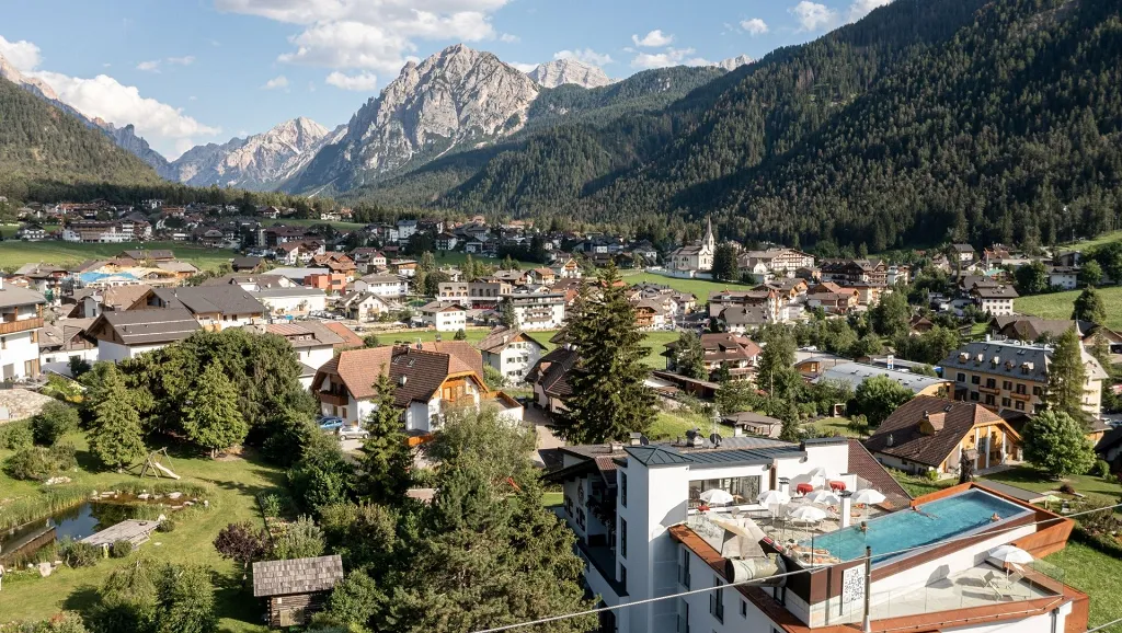 Outdoor summer with infinity pool on the roof and dolomites views of Hotel Al Plan