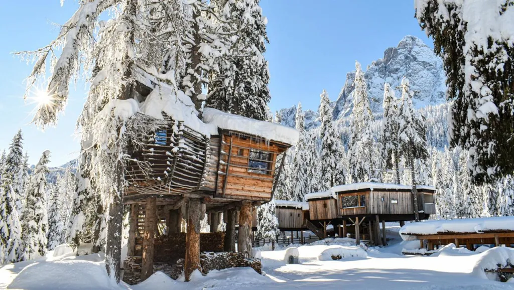 Snow landscape of tree house in the Caravan Park Sexten camping