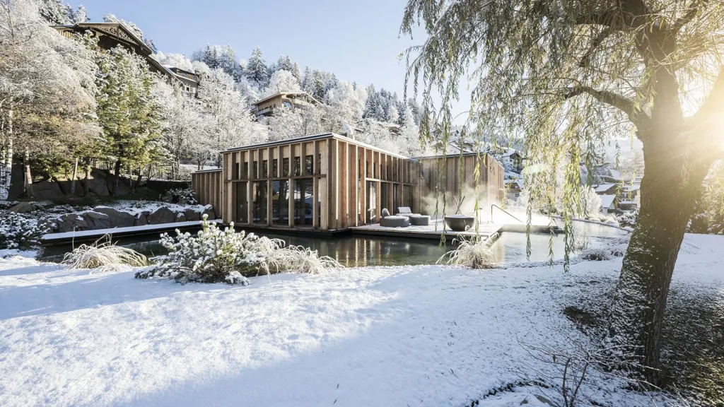 Sauna in the garden in winter in a snow landscape at ADLER Spa Resort DOLOMITI
