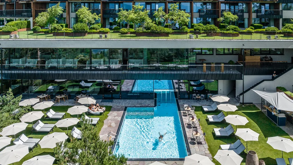 People swim in the outdoor Infinity pool of My Arbor Hotel