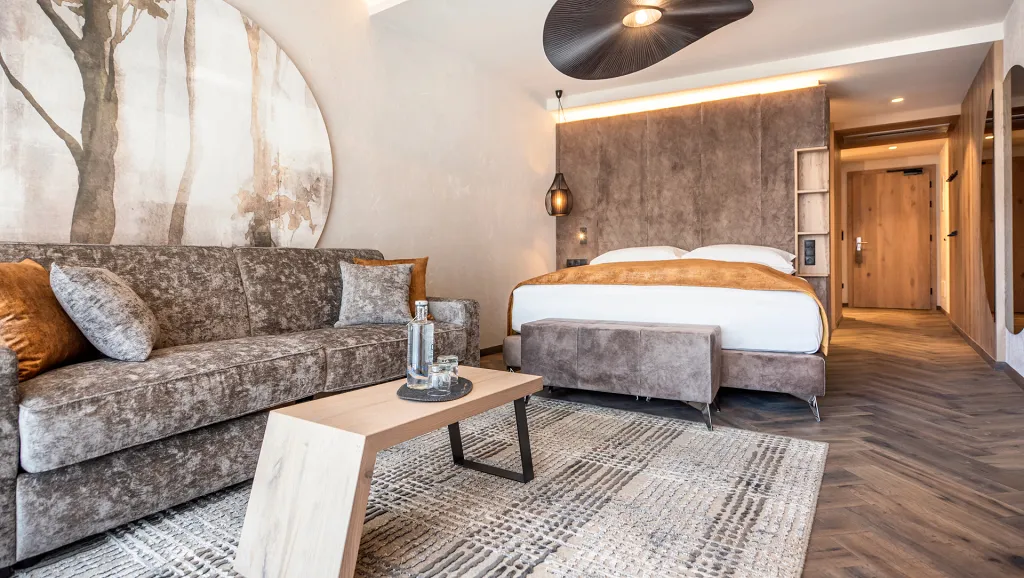 Arnika Suite with bed and living room of Quellenhof